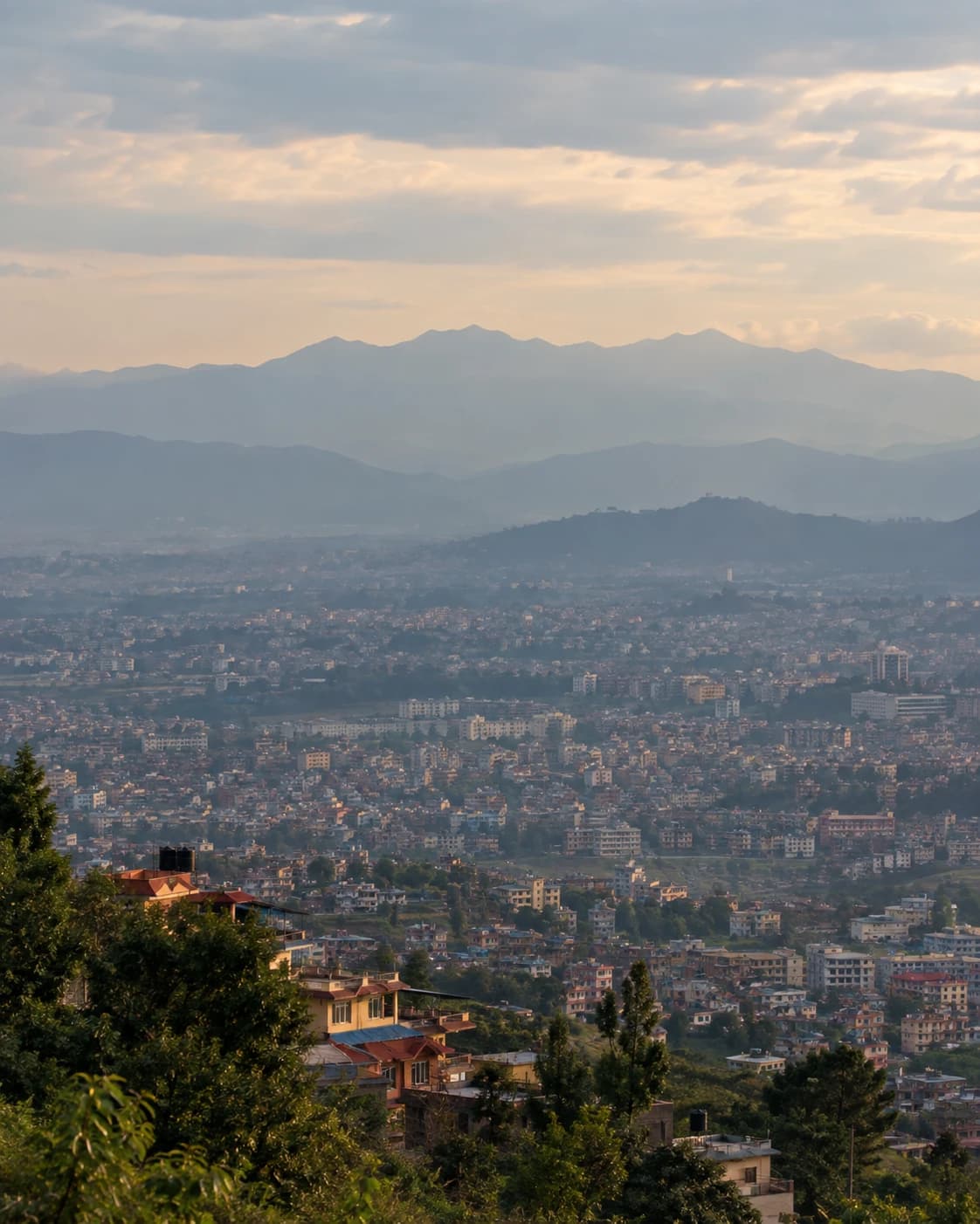 A city at dawn, seen from the hills above it